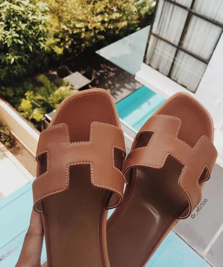 Brown Women's Leather H-Strap Sandals — Valerie Slip-On Flat - Outdoor Pose